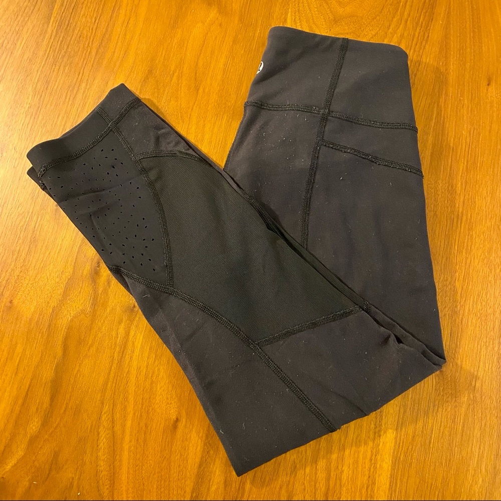 Black Lululemon Leggings with Laser Cutout Detail & Mesh Bottom